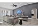 Spacious living room with gray sectional sofa and gray accent chairs at 2320 Blue Meadows Ct, Apopka, FL 32703