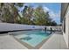 Inviting rectangular pool with a tanning ledge and a basketball hoop at 2320 Blue Meadows Ct, Apopka, FL 32703