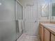 Bathroom with shower stall, vanity, and wood cabinets at 2371 Wilson Way, The Villages, FL 32162