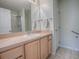 Bathroom with light wood cabinets and a single sink vanity at 2371 Wilson Way, The Villages, FL 32162