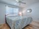 Bedroom with a queen-size bed, ceiling fan, and ample closet space at 2371 Wilson Way, The Villages, FL 32162