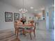 Bright dining room with wood table and kitchen view at 2371 Wilson Way, The Villages, FL 32162