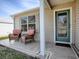 Small front porch with two wicker chairs at 2371 Wilson Way, The Villages, FL 32162