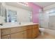 Bright bathroom featuring a vanity with wood cabinets and a shower-tub combo at 2385 Sw 159Th Ln, Ocala, FL 34473