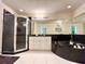 Bathroom featuring a black corner tub, glass shower, white cabinets, and a large vanity mirror at 2385 Sw 159Th Ln, Ocala, FL 34473