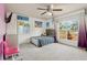 This bedroom features natural light from the large window, and a ceiling fan at 2385 Sw 159Th Ln, Ocala, FL 34473