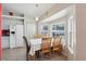 This breakfast nook features white appliances, wooden chairs, and a bright window at 2385 Sw 159Th Ln, Ocala, FL 34473