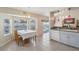 Bright kitchen with tile floor, dining area and a view of the screened-in pool at 2385 Sw 159Th Ln, Ocala, FL 34473