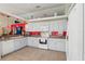 Bright kitchen featuring white cabinetry, modern appliances, red backsplash, and eat-in area at 2385 Sw 159Th Ln, Ocala, FL 34473