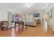 A view of the living room featuring laminate floors, a foosball table, and large window at 2385 Sw 159Th Ln, Ocala, FL 34473