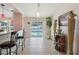 Bright living space featuring tile floors, a breakfast bar, and sliding glass doors leading to a screened pool at 2385 Sw 159Th Ln, Ocala, FL 34473