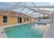 The in-ground pool sits next to a yellow house and a white fence at 2385 Sw 159Th Ln, Ocala, FL 34473