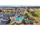 Aerial view showcasing a community pool, clubhouse, tennis courts, and lush landscaping within a well-maintained setting at 2420 Prairie Dunes, Clermont, FL 34711