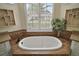 Relax in this garden tub with large window and granite accents at 2420 Prairie Dunes, Clermont, FL 34711