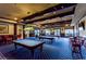 Billiard room featuring multiple pool tables, overhead lighting, and comfortable seating, perfect for recreation at 2420 Prairie Dunes, Clermont, FL 34711