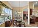 Bright breakfast nook with glass-top table and view of the pool at 2420 Prairie Dunes, Clermont, FL 34711