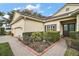 Landscaped front yard with brick walkway leading to the house entrance at 2420 Prairie Dunes, Clermont, FL 34711