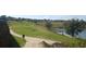 Scenic view of a well-maintained golf course with a lake and lush greenery at 2420 Prairie Dunes, Clermont, FL 34711