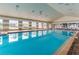 Bright indoor pool with large windows, lounge chairs, and a vaulted ceiling, creating a relaxing atmosphere at 2420 Prairie Dunes, Clermont, FL 34711