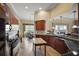 Spacious kitchen with island, dark wood cabinets, and stainless steel appliances at 2420 Prairie Dunes, Clermont, FL 34711