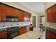 Modern kitchen with granite countertops and dark wood cabinets at 2420 Prairie Dunes, Clermont, FL 34711