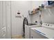 Laundry room with washer, dryer, and shelving at 2420 Prairie Dunes, Clermont, FL 34711