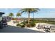 Outdoor patio area with tables, chairs, string lights, and palm trees overlooking a nice view at 2420 Prairie Dunes, Clermont, FL 34711