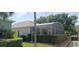 Back of home featuring a screened-in lanai at 2420 Prairie Dunes, Clermont, FL 34711