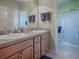 Clean bathroom with double vanity and walk-in shower at 2549 Buttonwood Run, The Villages, FL 32162