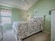 Charming bedroom with floral bedding and a ceiling fan at 2549 Buttonwood Run, The Villages, FL 32162