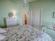 Serene bedroom with floral bedding and en-suite bathroom at 2549 Buttonwood Run, The Villages, FL 32162