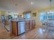 Kitchen island with stainless steel dishwasher and wood cabinets at 2549 Buttonwood Run, The Villages, FL 32162