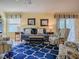 Living room with blue and yellow coastal decor and wood floors at 2549 Buttonwood Run, The Villages, FL 32162