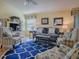 Living room with blue and yellow coastal decor and wood floors at 2549 Buttonwood Run, The Villages, FL 32162