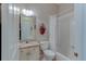 Clean bathroom with granite vanity, tub shower combo, and white tile at 25921 San Rafael Ct, Howey In The Hills, FL 34737