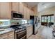 Modern kitchen with stainless steel appliances and granite countertops at 25921 San Rafael Ct, Howey In The Hills, FL 34737