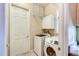 Laundry room with washer, dryer, and storage shelves at 25921 San Rafael Ct, Howey In The Hills, FL 34737