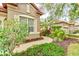 Walkway to the house entrance, surrounded by tropical plants at 25921 San Rafael Ct, Howey In The Hills, FL 34737