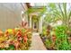 A walkway lined with colorful plants leading to a house entrance at 25921 San Rafael Ct, Howey In The Hills, FL 34737