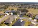 Wide aerial view of neighborhood with golf course visible at 26709 Augusta Springs Cir, Leesburg, FL 34748