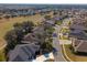 Aerial view of a residential neighborhood with houses and a golf course at 26709 Augusta Springs Cir, Leesburg, FL 34748