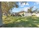 Exterior view of home featuring lush green lawn and screened in patio at 26709 Augusta Springs Cir, Leesburg, FL 34748