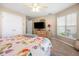 Bedroom with floral bedding and a dresser at 26709 Augusta Springs Cir, Leesburg, FL 34748