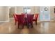 Dining area featuring a glass-top table and red upholstered chairs at 26709 Augusta Springs Cir, Leesburg, FL 34748