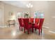 Bright dining room with a glass table and red chairs at 26709 Augusta Springs Cir, Leesburg, FL 34748