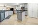 Open kitchen featuring grey cabinets, granite countertops, stainless appliances and tile flooring at 26709 Augusta Springs Cir, Leesburg, FL 34748