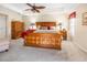 Main bedroom with wooden bed frame and red accents at 26709 Augusta Springs Cir, Leesburg, FL 34748