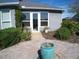 Well-manicured backyard patio with a brick walkway and a decorative water feature at 314 Salt Marsh Ln, Groveland, FL 34736