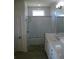 Bathroom with walk-in shower and double vanity at 314 Salt Marsh Ln, Groveland, FL 34736