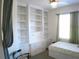 Bedroom featuring custom built-in shelving, drawers, and ample storage space at 314 Salt Marsh Ln, Groveland, FL 34736